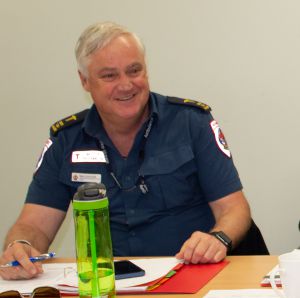 Mark Scammel smiling while sitting at a desk