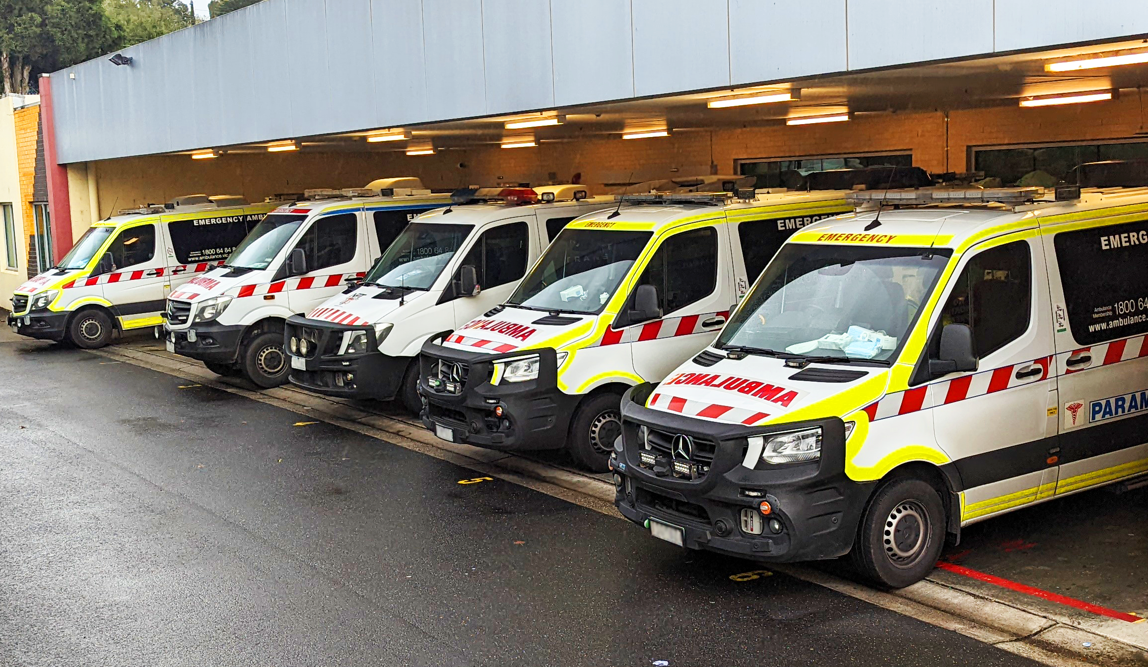 A row of ambulances in a waiting bay